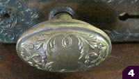 Decorative oval stamped brass doorknob